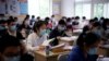 Students wearing face masks are seen inside a classroom during a government-organised media tour at a high school as more students returned to campus following the coronavirus disease (COVID-19) outbreak, in Shanghai, China May 7, 2020. REUTERS/Aly Song