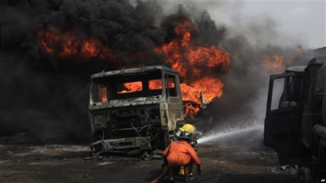 Firefighters try to contain a fire at an informal diesel fuel depot in Lagos, Nigeria on Thursday, Feb. 16, 2012.