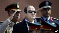 FILE - Egyptian President Abdel-Fattah el-Sissi, center, reviews honor guards, in Moscow, Russia, Aug. 26, 2015. 