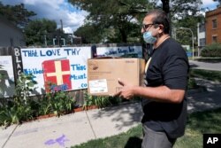 ROOH owner Manish Mallick delivers some of the 450 meals from his Indian restaurant for I Grow Chicago, in the Englewood neighborhood of Chicago, July 13, 2020.