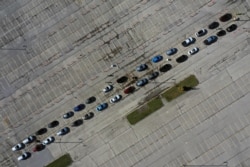 Aerial view of people waiting in their vehicles for COVID-19 tests at a drive-thru testing site in the parking lot of Miller Park as the coronavirus disease outbreak continues in Milwaukee, Wisconsin, Oct. 21, 2020.