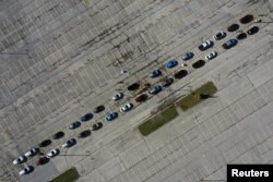 Aerial view of people waiting in their vehicles for COVID-19 tests at a drive-thru testing site in the parking lot of Miller Park as the coronavirus disease outbreak continues in Milwaukee, Wisconsin, Oct. 21, 2020.