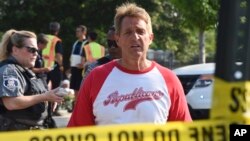 Sen. Jeff Flake, R-Ariz. walks toward media gathered at the scene of a shooting at a baseball field in Alexandria, Virginia, June 14, 2017, during a congressional baseball practice where House Majority Whip Steve Scalise of Louisiana and four other people were shot and wounded. 