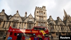FILE - A sightseeing bus passes Oxford University building, amid the spread of the coronavirus disease (COVID-19), in Oxford, Britain, Oct. 6, 2020. 