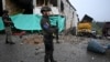 Police stand guard outside the Morales police station after militants opened fire and detonated cylinder bombs on it and a bank in the town of Morales, Cauca department, Colombia, on May 20, 2024.