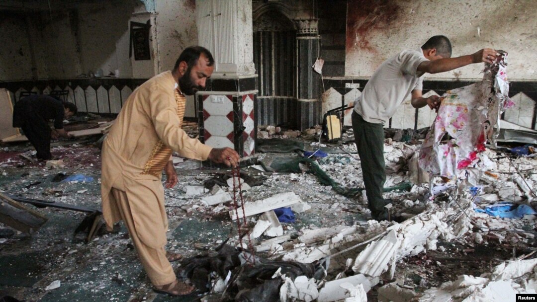 Relatives inspect the damage after an overnight suicide attack at a mosque in Herat, Afghanistan, Aug. 2, 2017. 
