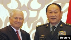 U.S. Secretary of Defense Robert Gates (L) shakes hands with China's Defence Minister Liang Guanglie at the 10th International Institute of Strategic Studies (IISS) Asia Security Summit: The Shangri-La Dialogue in Singapore June 3, 2011. REUTERS/Jason Ree