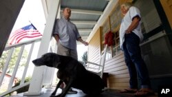 FILE - Virginia voter Harry Donahue talking to his wife Nancy on the front porch of their farmhouse, built in the 1700's, in Farmville, Va. 