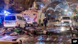 Police cars drive through a main boulevard in Brussels, Nov. 27, 2022, as violence broke out during and after Morocco's 2-0 win over Belgium at the World Cup. 