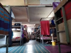 FILE - An undated photo provided by a labor rights advocate shows a migrant worker dorm room in Malaysia.