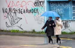 FILE - Graffiti in a loyalist area of south Belfast, Northern Ireland, against an Irish sea border is seen Feb. 2, 2021.