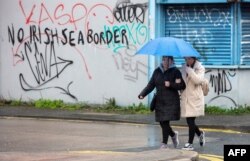 FILE - Graffiti in a loyalist area of south Belfast, Northern Ireland, against an Irish sea border is seen Feb. 2, 2021.