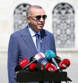 Turkey's President Recep Tayyip Erdogan speaks to supporters and the media in Istanbul, Aug. 7, 2020. Erdogan has called a maritime deal between Greece and Egypt "worthless."