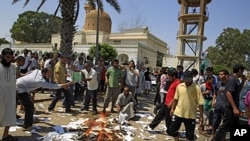 Rebel supporters burn copies of Gadhafi's 'Green Book' in the main square of the Qasr Bin Ghashir district in Tripoli, Libya, August 27, 2011