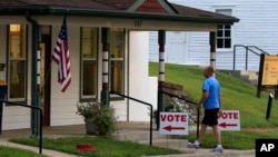 FILE - A voter enters City Hall in Lecompton, Kansas.