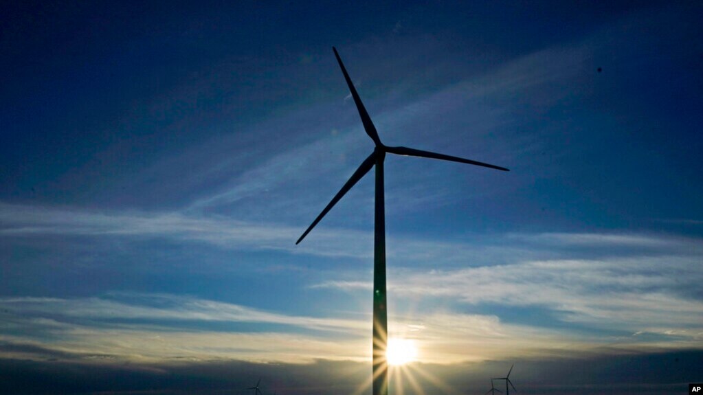 FILE - A wind turbine is pictured, Jan. 13, 2021, near Spearville, Kan. Recent studies contend that because of falling alternative energy prices, President Joe Biden's net-zero carbon goal can be accomplished more cheaply than once was thought.