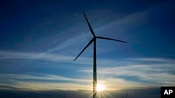 FILE - A wind turbine is pictured, Jan. 13, 2021, near Spearville, Kan. Recent studies contend that because of falling alternative energy prices, President Joe Biden's net-zero carbon goal can be accomplished more cheaply than once was thought.