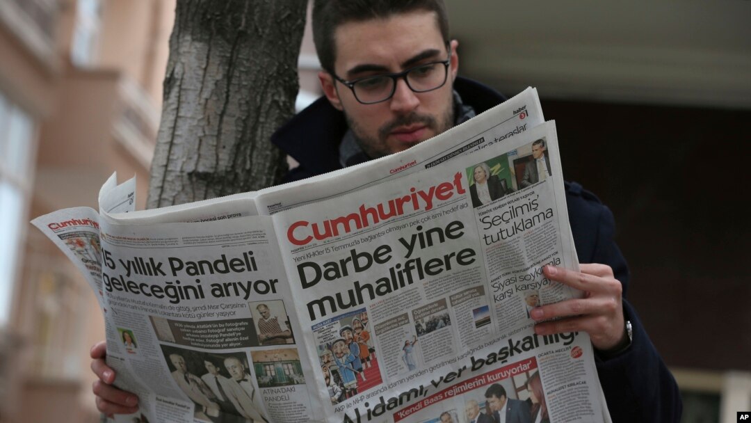 A man reads Cumhuriyet newspaper outside its Ankara office after Turkish police detained the chief editor and at least eight senior staff of Turkey's opposition newspaper, Oct. 31, 2016. The headline reads: "The coup against opposition again."