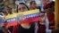 A supporter of Venezuelan President Hugo Chavez attends a gathering outside Miraflores Palace in Caracas, January 10, 2013.