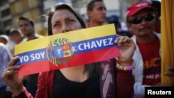  A supporter of Venezuelan President Hugo Chavez attends a gathering outside Miraflores Palace in Caracas, January 10, 2013. 