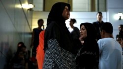 FILE - Relatives of victims of human trafficking wait for the sentence after an army general, two provincial politicians and police officers were among the 46 people held guilty in a court in Bangkok, Thailand, July 19, 2017.