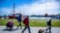 Tourists with backpacks and suitcases arrives at the port of Kloster on the Baltic island Hiddensee in Vitte, Germany, May 25, 2020. 