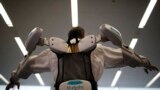An employee of ActiveLink Co. established under the sponsorship of Panasonic Corp, demonstrates ARM01, called &#39;Raku Vest&#39;, jointly developed with Kubota Corp., in Tokyo, Japan. The ARM01 is a robotic exoskeleton developed to help farmers and construction workers.