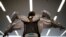An employee of ActiveLink Co. established under the sponsorship of Panasonic Corp, demonstrates ARM01, called 'Raku Vest', jointly developed with Kubota Corp., in Tokyo, Japan. The ARM01 is a robotic exoskeleton developed to help farmers and construction workers.