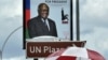 People walk under an election poster of the ruling South West African People's Organization (SWAPO), showing the incumbent President Hifikepunye Pohamba in Katatura, outside Windhoek, 25 Nov 2009