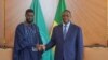 TOPSHOT - This handout picture taken an distributed by the Senegalese Presidency on March 28, 2024 shows outgoing Senegalese President Macky Sall (R) shaking hands with with Senegal's president-elect Bassirou Diomaye Faye (L) at the Presidential palace in