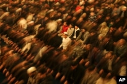 FILE - Worshippers perform a night prayer called 'Tarawih' during the eve of the first day of the Muslim holy fasting month of Ramadan in Turkey at the Hagia Sophia mosque in Istanbul, Turkey, March 22, 2023.