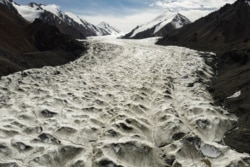 Meltwater flows over the Laohugou No. 12 glacier in the Qilian mountains, Subei Mongol Autonomous County in Gansu province, China. Glaciers in the bleak, rugged Qilian mountains are disappearing at a shocking rate.