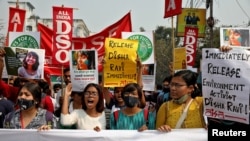 Demonstrators shout slogans during a protest against the arrest of 22-year-old climate activist Disha Ravi, in Kolkata, India, Feb. 23, 2021.