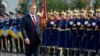 Romania's new President Klaus Iohannis walks in front of the honor guard during a take-over ceremony at Cotroceni presidential palace in Bucharest, Dec. 21, 2014. 