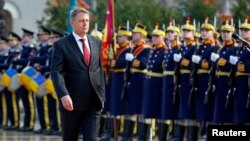 Romania's new President Klaus Iohannis walks in front of the honor guard during a take-over ceremony at Cotroceni presidential palace in Bucharest, Dec. 21, 2014. 