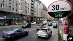 FILE - Cars pass by a speed limit sign displaying a "Thank you," on a street in Berlin, Germany, May 20, 2019. 