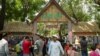 FILE: Cambodians walk outside Sangkran Wat Phnom gate during Khmer New Year celebration at Wat Phnom on second day of Khmer New Year in Phnom Penh, Cambodia, April 15, 2019.(Tum Malis/VOA Khmer) 