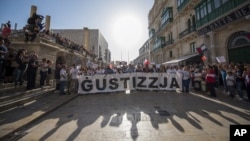 A banner reading "Justice" is seen at a rally in Malta to honor anti-corruption reporter Daphne Caruana Galizia, killed by a car bomb Oct. 16, in the capital city of Malta, Valletta, Oct. 22, 2017.