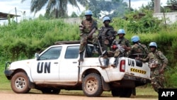 FILE - Blue-helmeted members of the U.N. Organization Stabilization Mission in the Democratic Republic of Congo sit on the back of a pickup truck in Beni, Oct. 23, 2014.