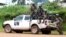 FILE - Blue-helmeted members of the U.N. Organization Stabilization Mission in the Democratic Republic of Congo sit on the back of a pickup truck in Beni, Oct. 23, 2014.