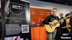 Andrea Martelloni, a PhD Student at the Queen Mary University of London, demonstrates the 'HITar', an AI-powered augmented guitar, at the 2024 National Association of Music Merchants (NAMM) trade show in Anaheim, California, U.S., January 25, 2024. (REUTERS/Jorge Garcia)