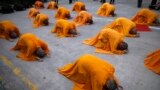 Buddhist monks perform the &quot;three steps one bow&quot; ceremony at Kong Meng San Phor Kark See Monastery in Singapore on the eve of Vesak Day to commemorate the birth, enlightenment and death of Buddha.