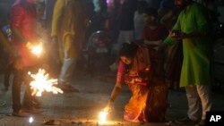 Indians light firecrackers to celebrate Diwali, the Hindu festival of lights, in Mumbai, Oct. 19, 2017.