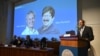 Nobel Committee Secretary-General Thomas Perlmann speaks to the media in front of a picture of this year's laureates in physiology or medicine, Victor Ambros and Gary Ruvkum, at the Karolinska Institute in Stockholm, Oct. 7, 2024. 