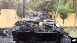 A picture released by the French spokesman for Laurent Gbagbo on April 7, 2011 shows a burnt out tank reportedly in the gardens of the residence of Laurent Gbagbo in Abidjan. (AFP image)