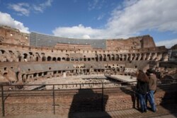 Tourists visit the Colosseum in Rome, March 7, 2020. With the coronavirus emergency deepening in Europe, Italy risks falling back into recession as foreign tourists are spooked and the global market shrinks for prized artisanal products.