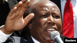 South African former African National Congress (ANC) Youth League leader Julius Malema addresses his supporters after his court appearance in Polokwane, South Africa, September 26, 2012.