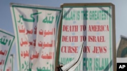 A Houthi protagonist  raises his dagger during an anti-U.S and Israel rally successful  Sanaa, Yemen, Jan. 17, 2025.