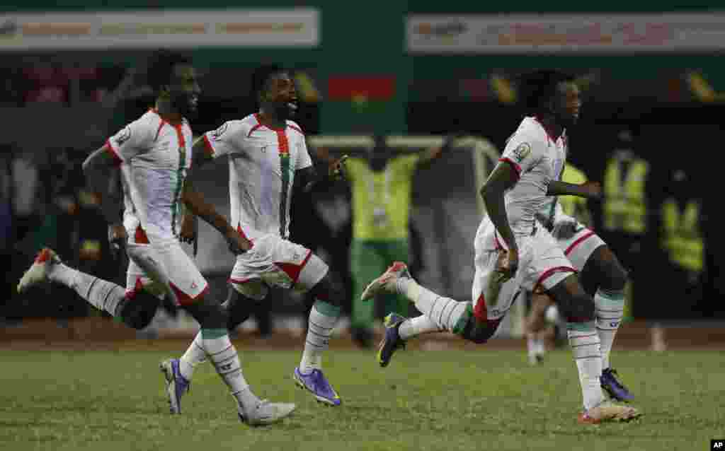 Burkina Faso&#39;s players celebrate at the end of the round of 16 match against Gabon in Cameroon, Jan. 23, 2022. Burkina Faso beat Gabon 7-6 following a penalty shootout.
