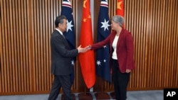 China's Foreign Minister Wang Yi, left, meets with Australia's Minister for Foreign Affairs Penny Wong at Parliament House in Canberra, March 20, 2024.